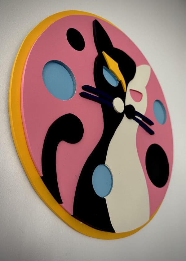 A clock with a cat on it's face.