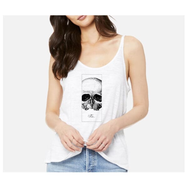 A woman wearing white tank top with a picture of a skull.