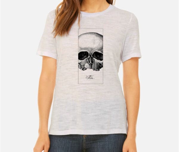 A woman wearing a white t-shirt with a skull on it.