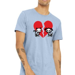 A man wearing a light blue t-shirt with two skulls and hearts.