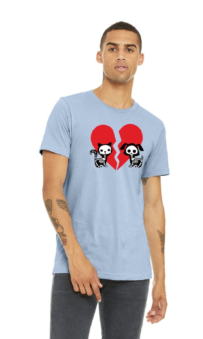 A man wearing a light blue t-shirt with two skulls and hearts.