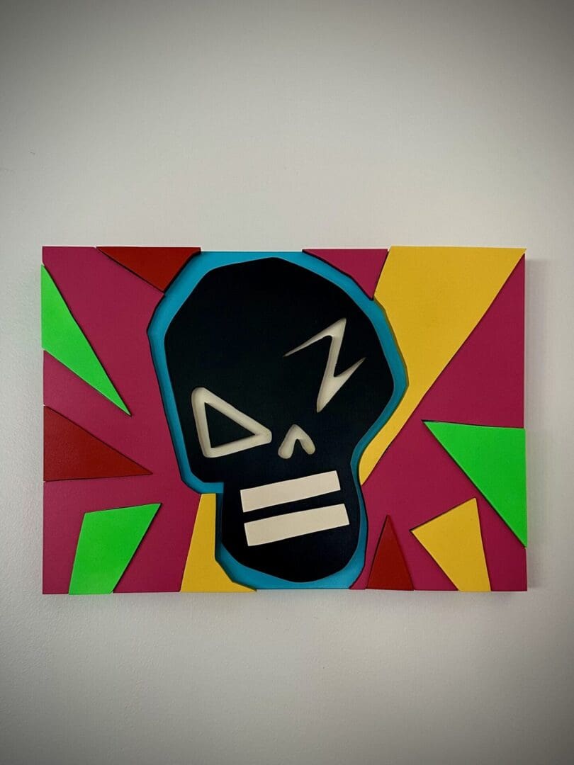 A painting of a skull with a black face and colorful background.